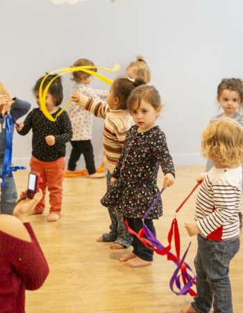 Groupe d'enfants jouant ensemble dans une salle d'activité au sein d'une crèche Babilou