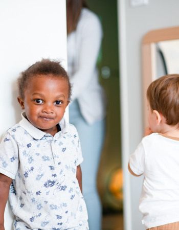 Enfant en crèche, au milieu d'un autre groupe d'enfants