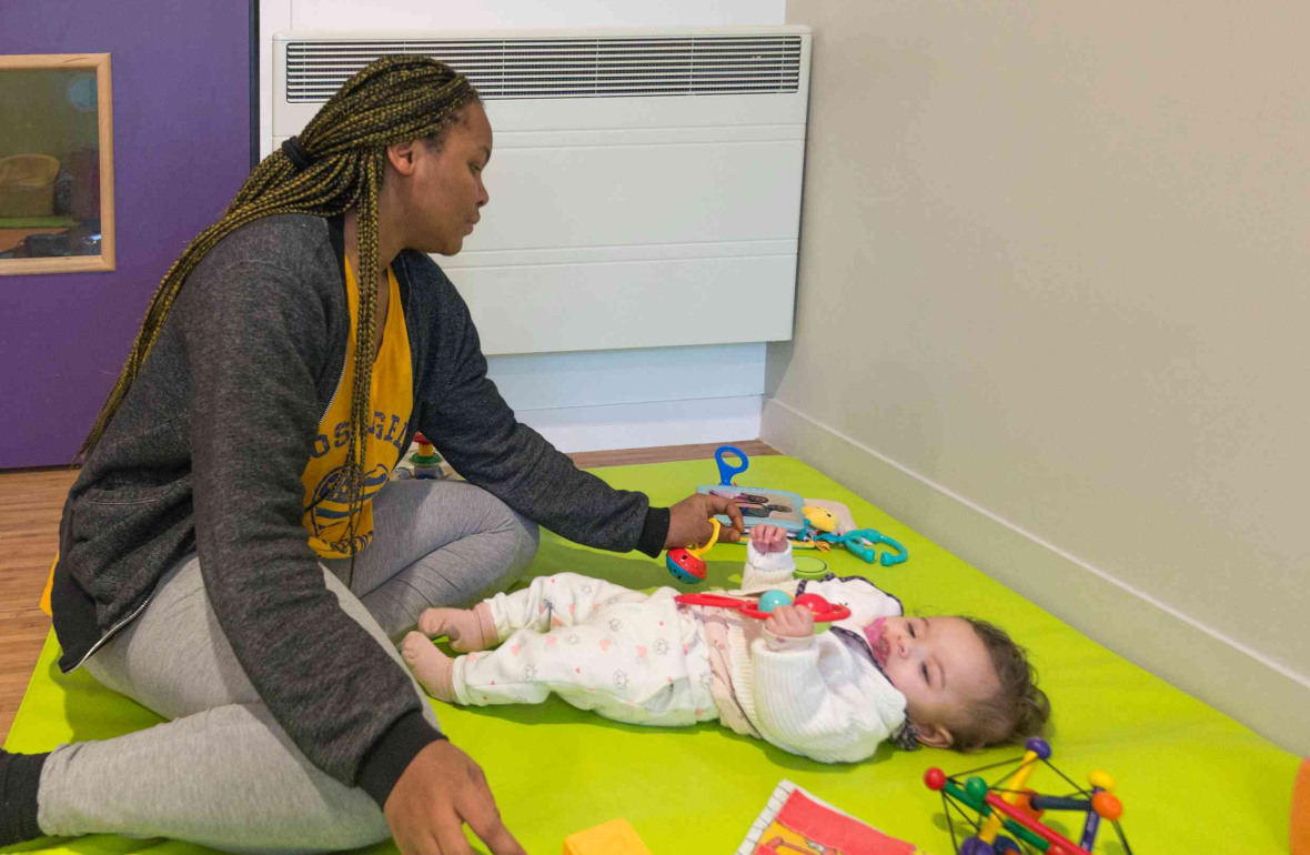 Une pro en crèche qui joue avec un bébé