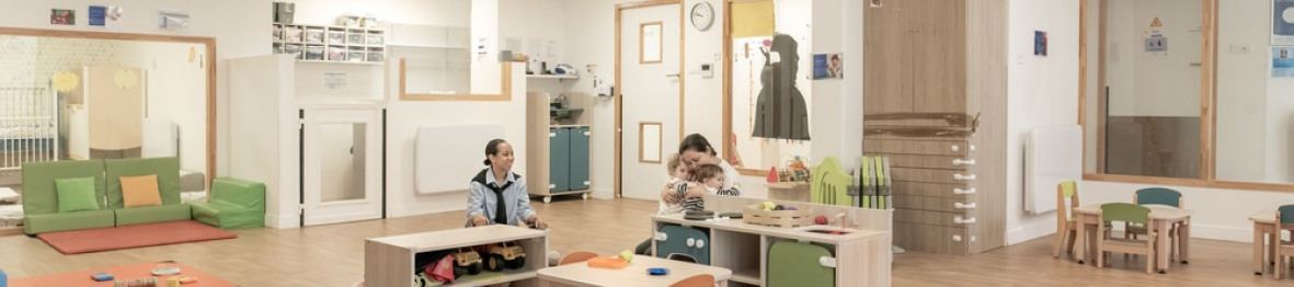 Une professionnelle en crèche en activité avec un enfant