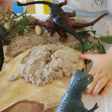 Un petit garçon jouant avec des jouets en forme de dinosaure 