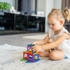 Petite fille jouant à un jeu de construction magnétique 